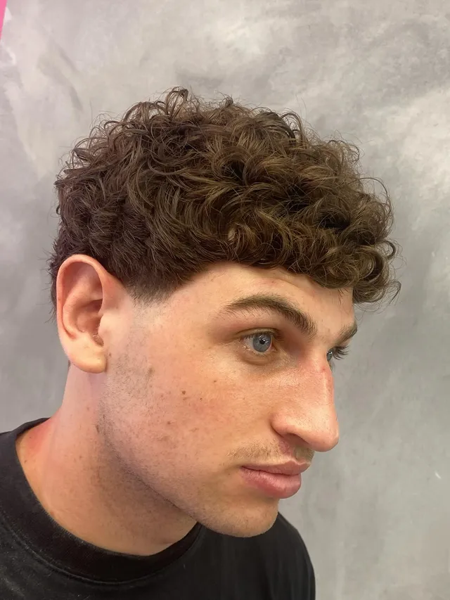 Curls over a low taper fade