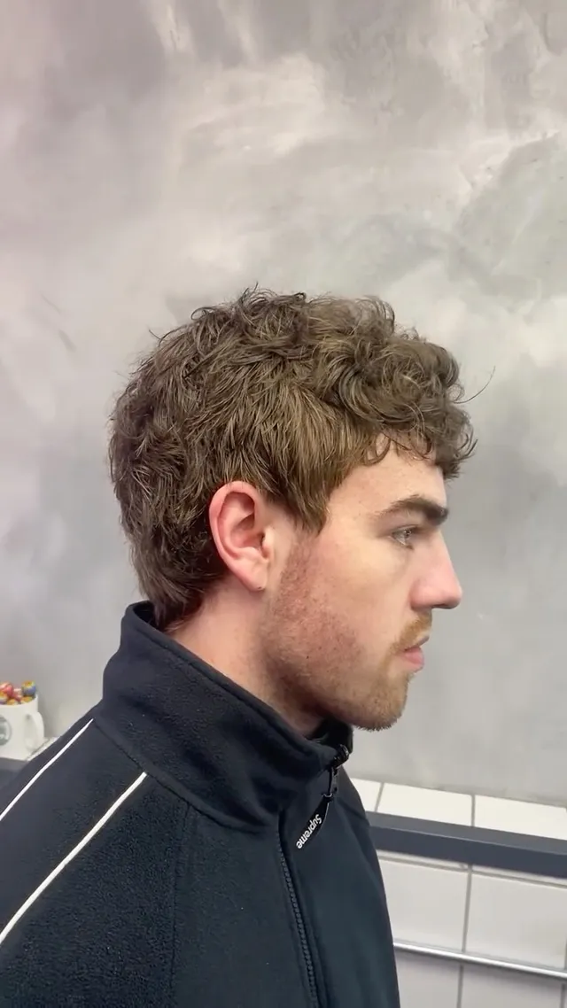 A curly mullet cut by Oli